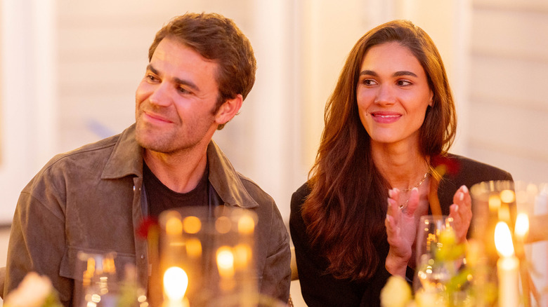 Paul Wesley and Natalie Kuckenburg sitting