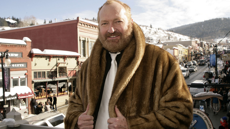 Randy Quaid in fur coat outside