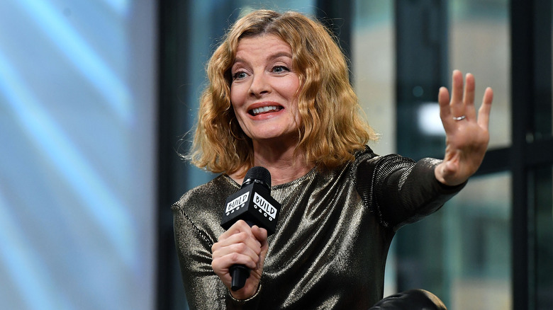 Rene Russo holding microphone