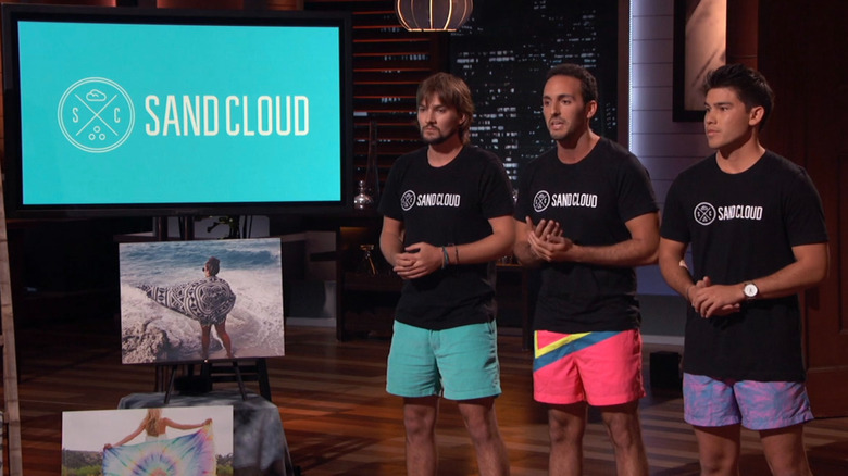 Sand Cloud creators presenting next to display