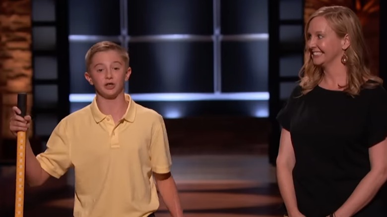 Maddox presents to the sharks next to his smiling mom