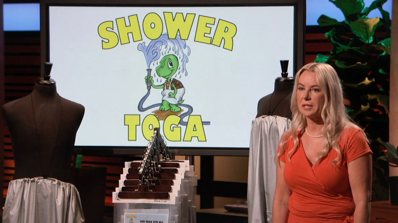 Kressa presenting next to Shower Toga display