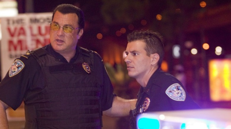 Steven Seagal stands with police officer