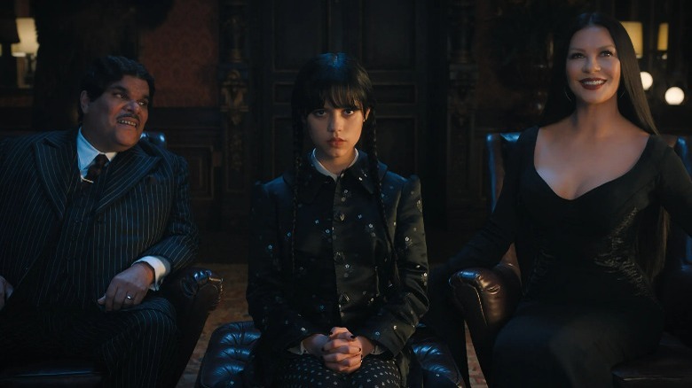 Gomez, Wednesday, and Morticia Addams sitting down