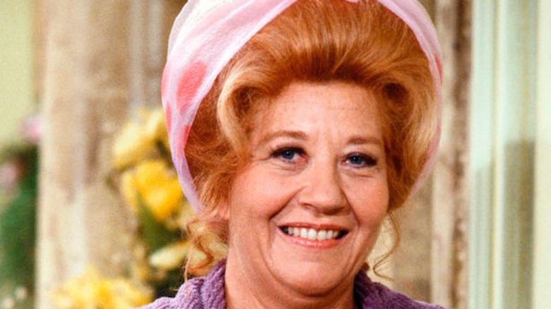 Charlotte Rae in head scarf smiles