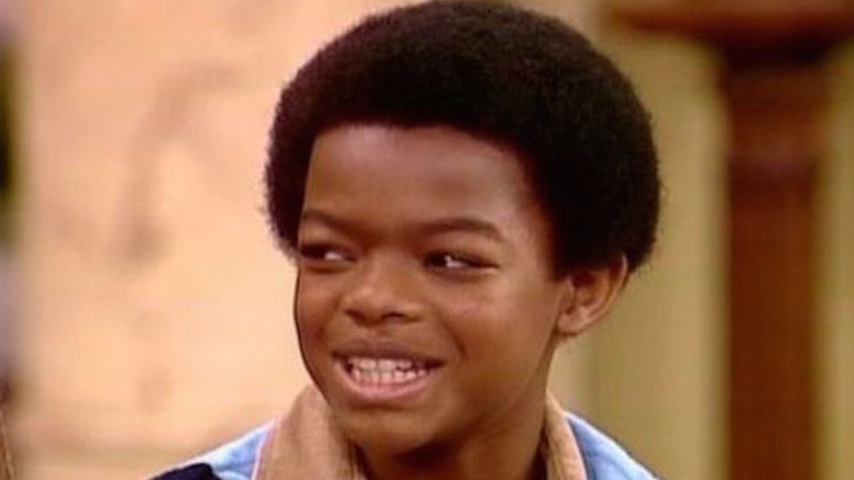 Todd Bridges smiles while looking to the side