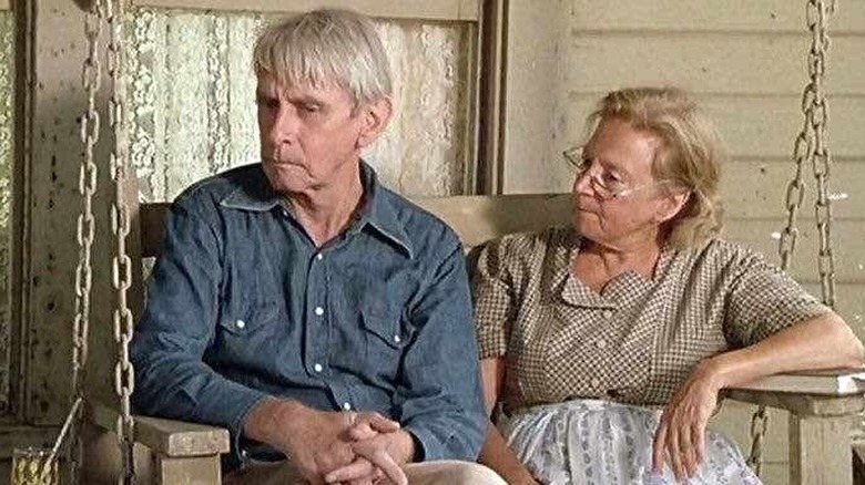 Robert Sorrells and Penny Stanton sit on a porch