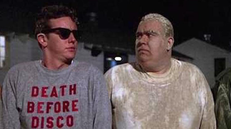 Judge Reinhold wears sunglasses, looks at John Candy