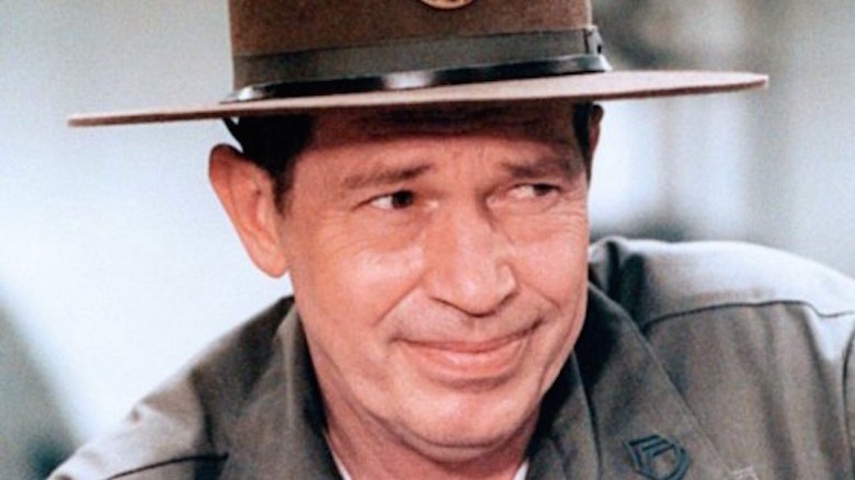 Warren Oates smiles warily