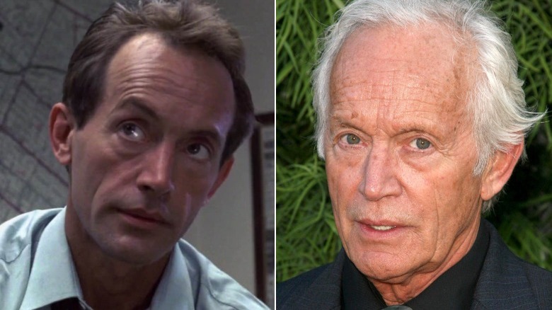 Vokovich tilts head/Lance Henriksen in front of plants