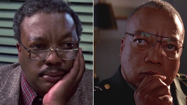 Traxler rests his chin on his hand/Paul Winfield in Mars Attacks with hand to mouth