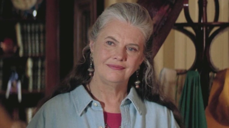 lois smith in light blue shirt, head tilted