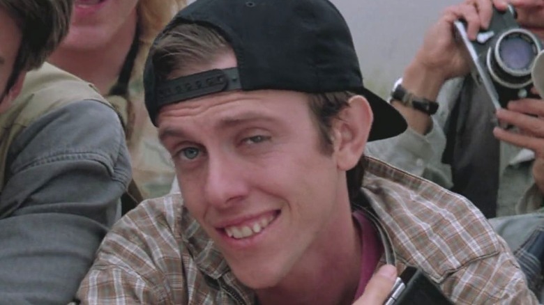 sean whalen smiling, black backward cap and plaid shirt