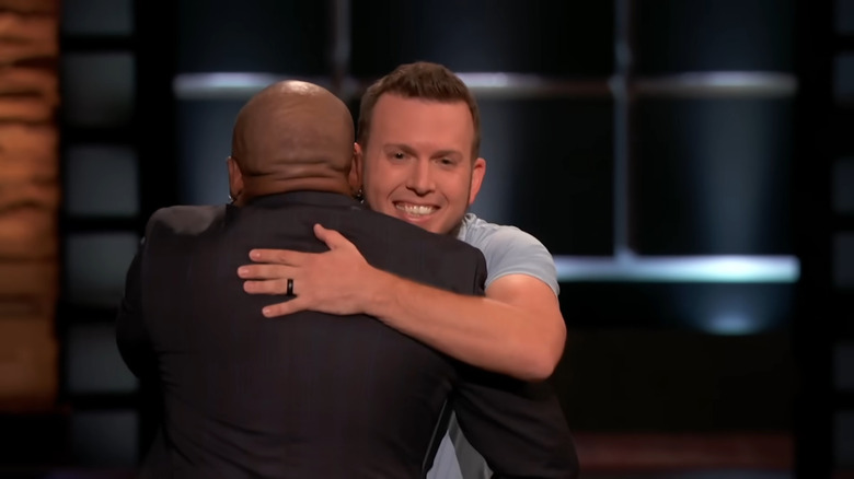 Daymond John hugs Les Cookson