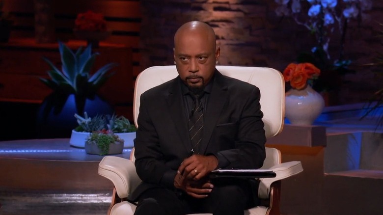 Daymond John sitting in a white chair