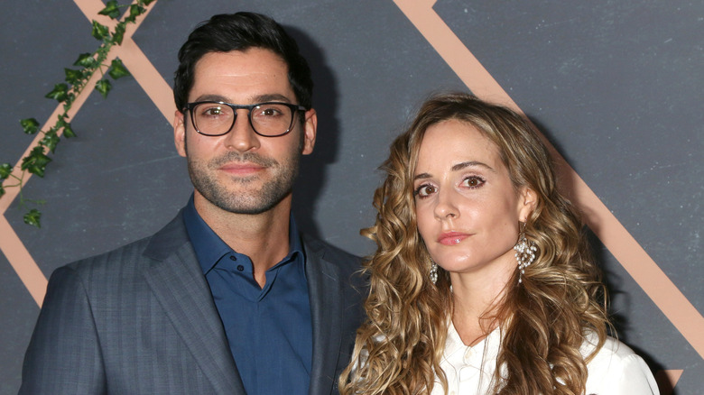 Tom Ellis smiles with his wife