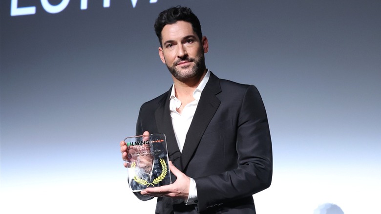 Tom Ellis accepts an award