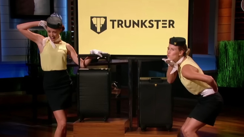 Actresses posing next to Trunkster display