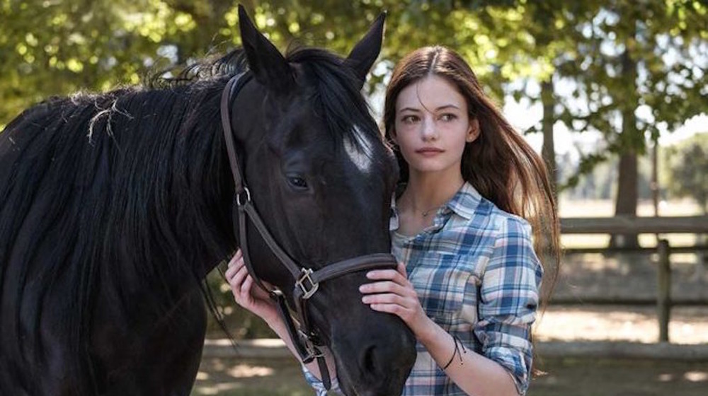 Mackenzie Foy hugging horse