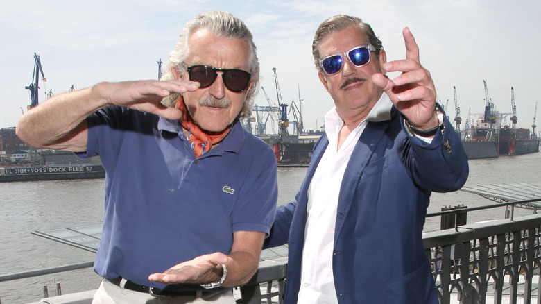 Boris Blank and Dieter Meier in front of boats