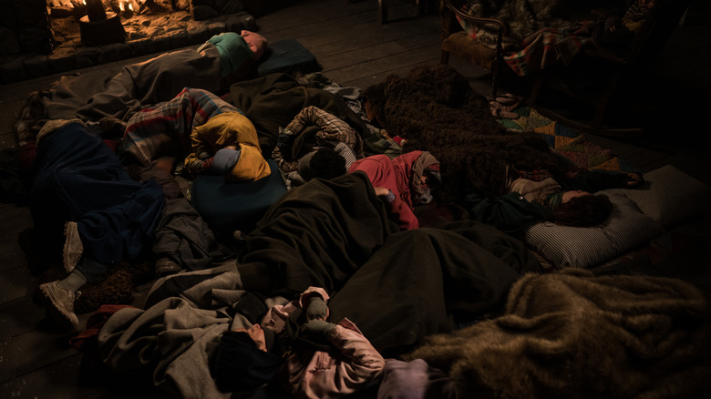 Girls sleeping on floor of cabin