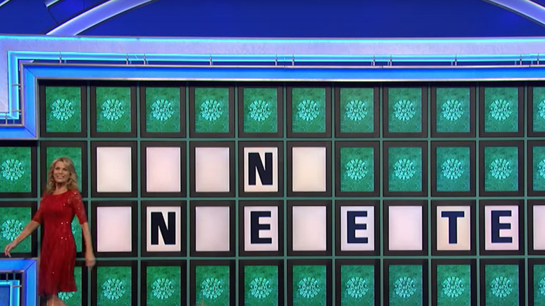 Vanna White turns over some letters in Wheel of Fortune