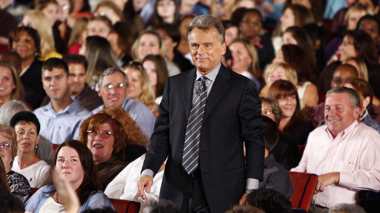 Pat Sajak standing up in an audience 