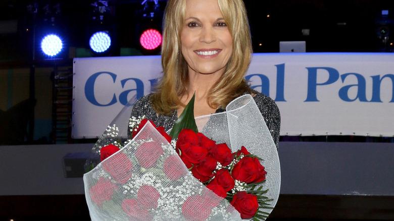 Vanna White holding a bouquet of flowers