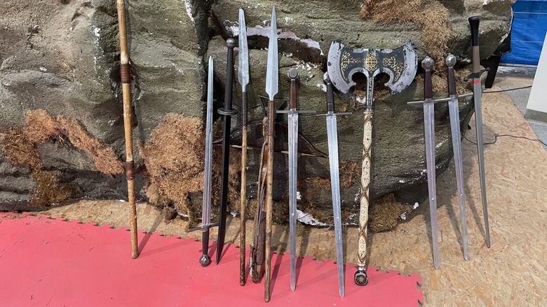 A selection of weapons leaning against a rock