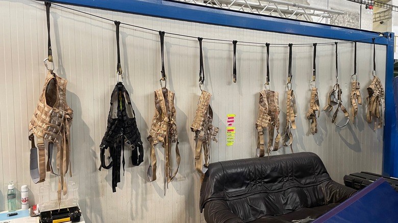 A line of harnesses hanging on a wall