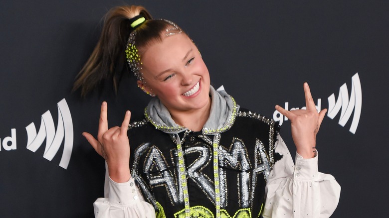 JoJo Siwa gestures at the 35th Annual GLAAD Awards