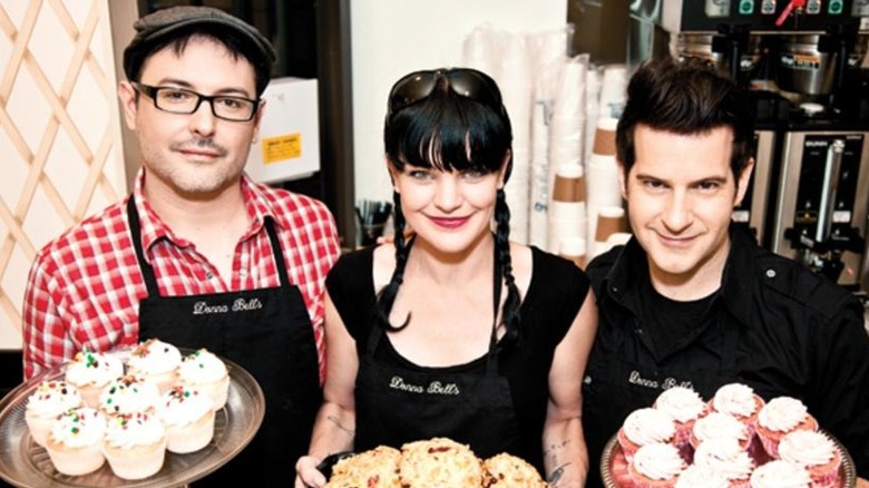 Darren, Pauley, and Matthew holding cupcakes and smiling