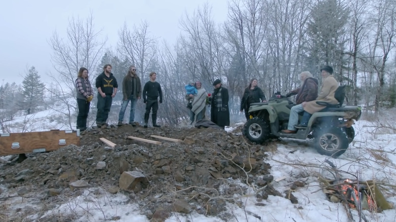 The brown family huddle around a pit