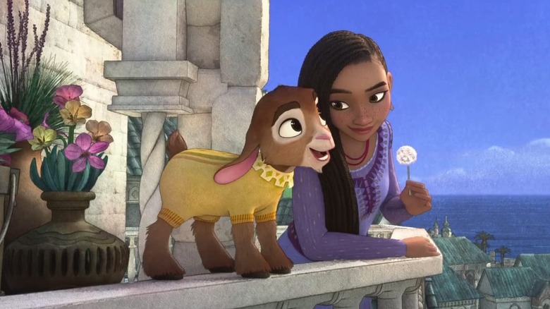 Asha standing on a balcony with her goat