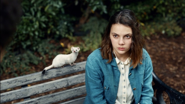 Lyra and Pan sitting on a park bench