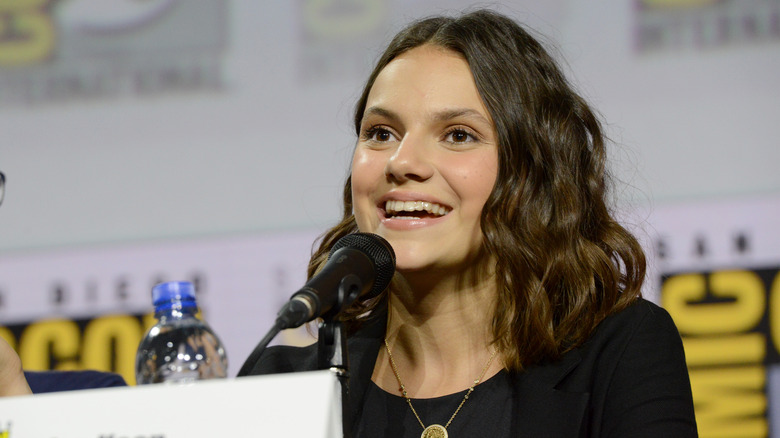 Dafne Keen speaking into a microphone