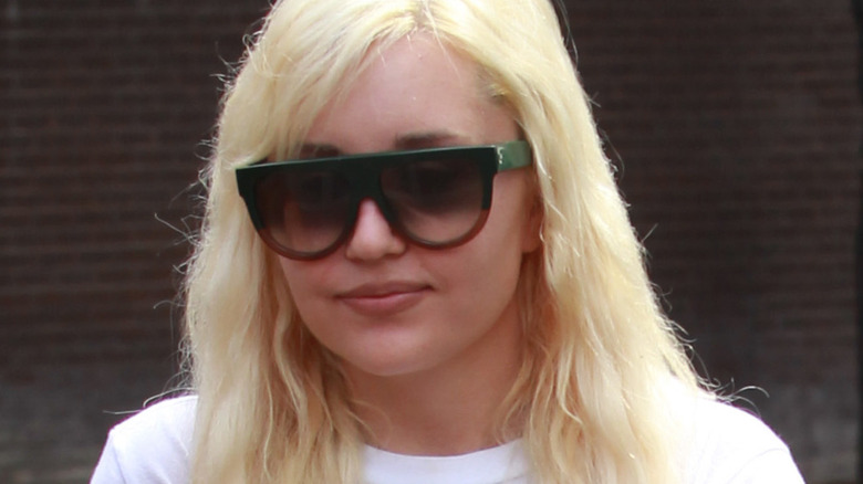 Amanda Bynes outide walking in sunglasses