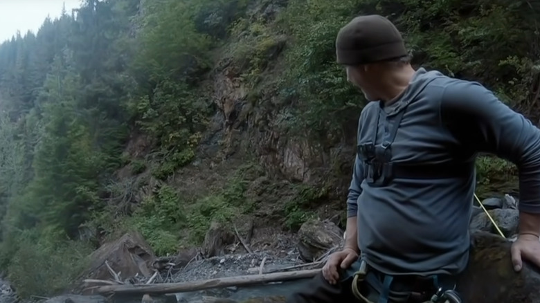 A member of Gold Rush: White Water surveys a rushing river