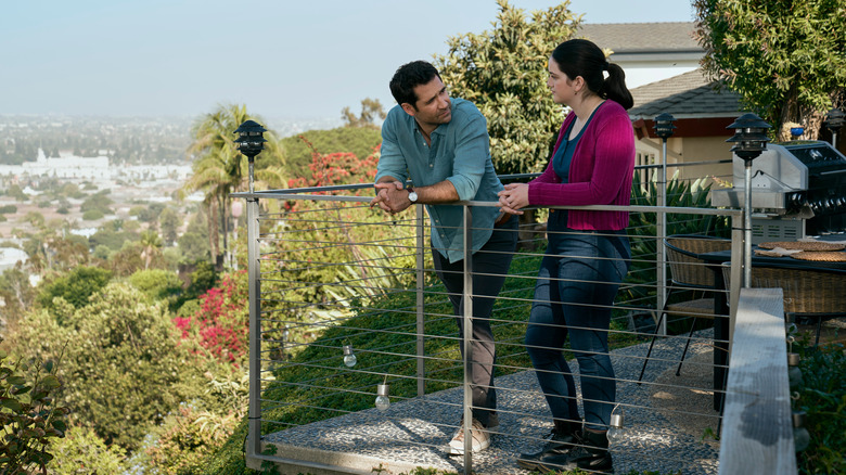 Mickey and Hayley leaning against balcony