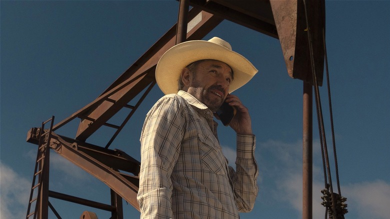 Tommy Norris talking on the phone in front of an oil pump (2024)