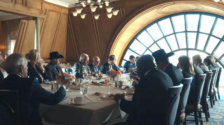 A business lunch in a fancy suit with a large arched window overlooking the city