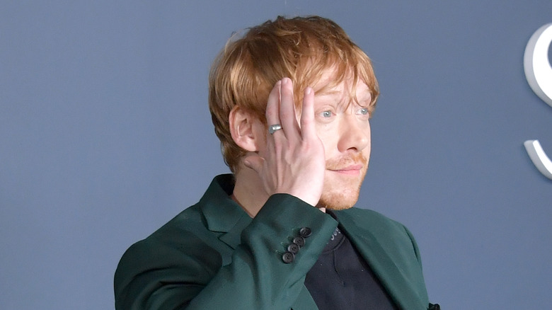 Rupert Grint hiding face