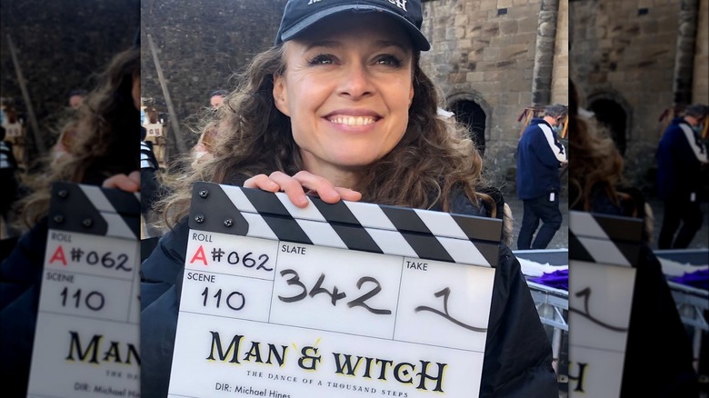 Tami Stronach holding Man & Witch clapperboard