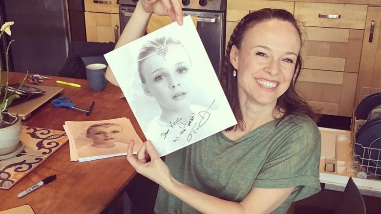 Tami Stronach holds up signed photo