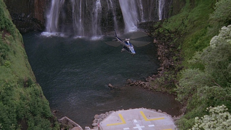 Helicopter landing near waterfall