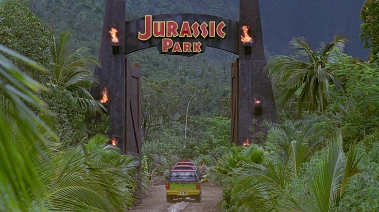 Jeeps driving through Jurassic Park gate