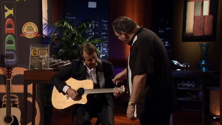 Robert Herjavec playing guitar with ChordBuddy