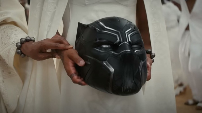 Hands carry Black Panther helmet