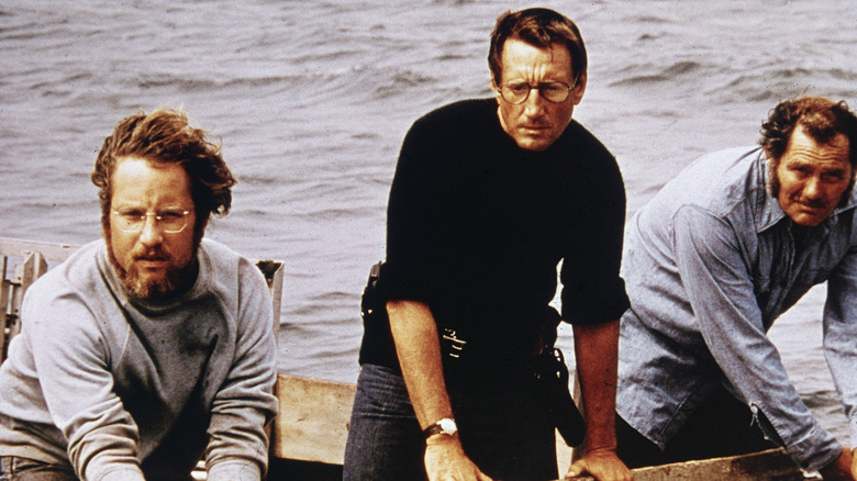 Quint, Martin Brody, and Matt Hooper look out at the sea in Jaws (1975)