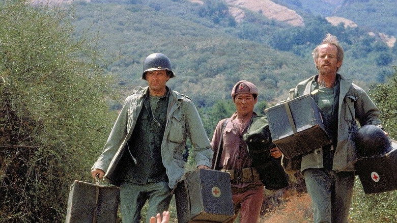 Hawkeye, BJ, and soldier running to help in the mountains